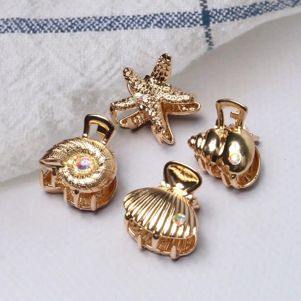 Set de 4 pinzas doradas marineras