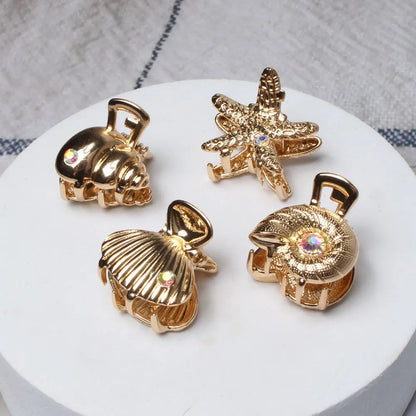Set de 4 pinzas doradas marineras